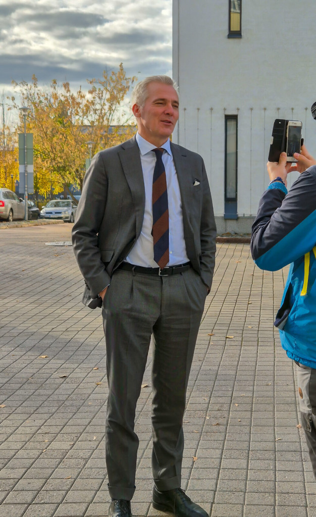 Etualalla opiskelija, joka kuvaa puhelimella Opetusministeri Anders Adlercreutzin haastattelua.