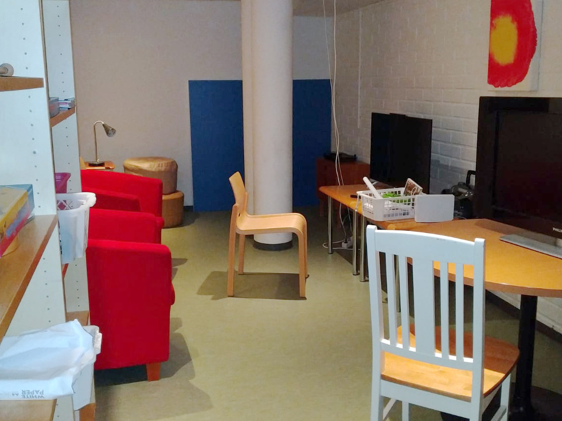 Asutonloan yhteistä tilaa, jossa tuoleja, pöytiä ja sohva.