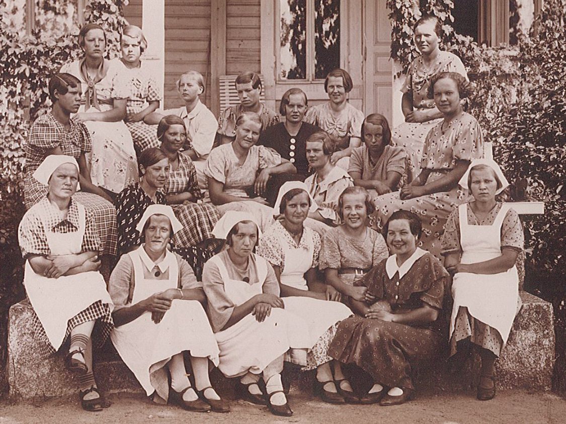 Group picture of women on a porch outside.